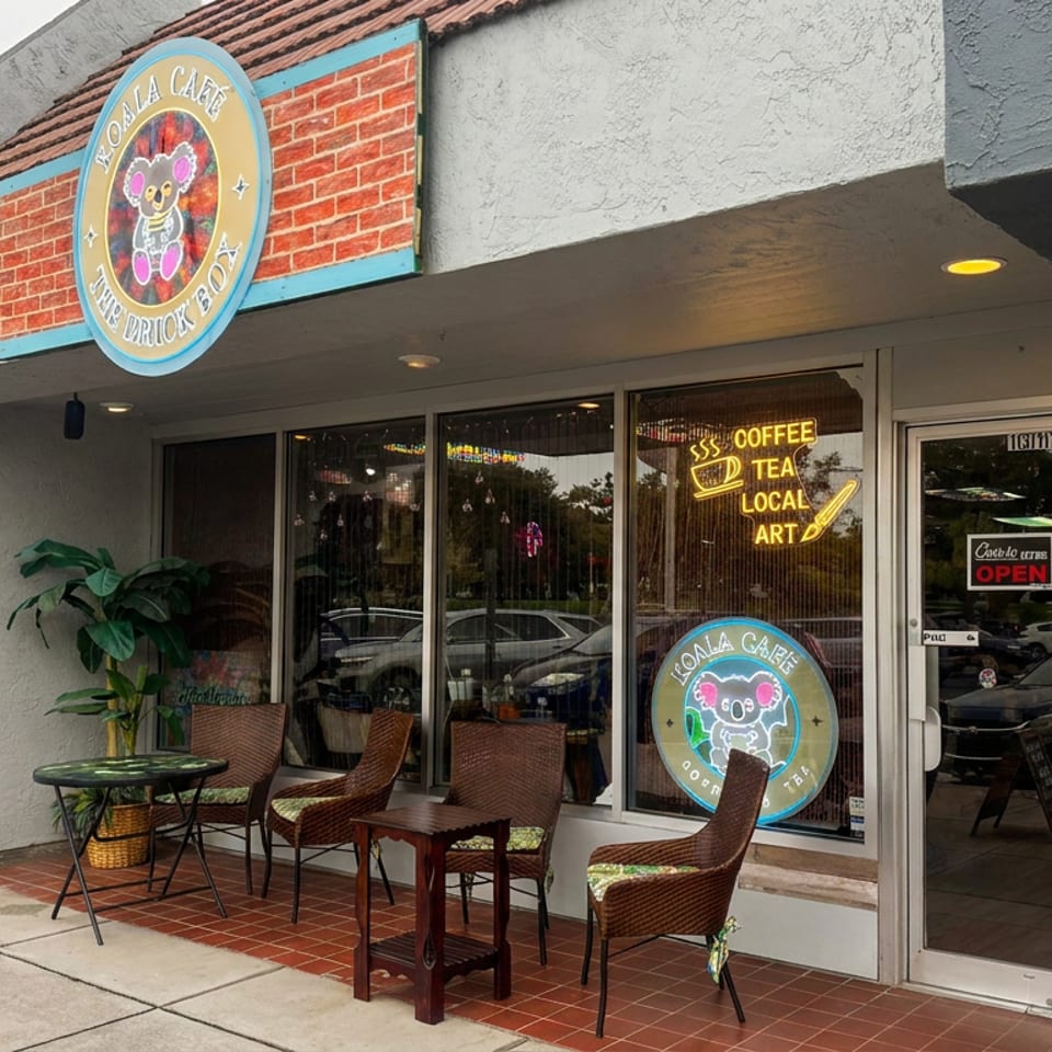 Yola Cafe storefront with colorful signage, coffee and tea lettering, and outdoor wicker seating along the sidewalk.